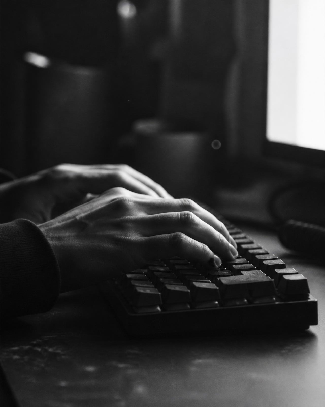Hands typing on a mechanical keyboard